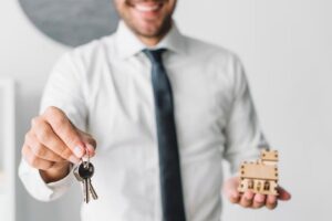 crop-real-estate-agent-with-keys-house_23-2147797578-min